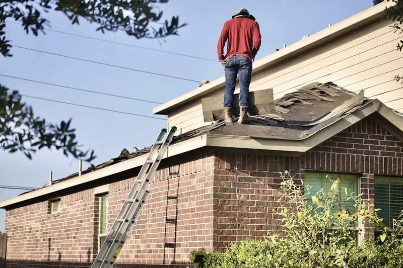 Professional roofer working on a residential roof in San Je Village